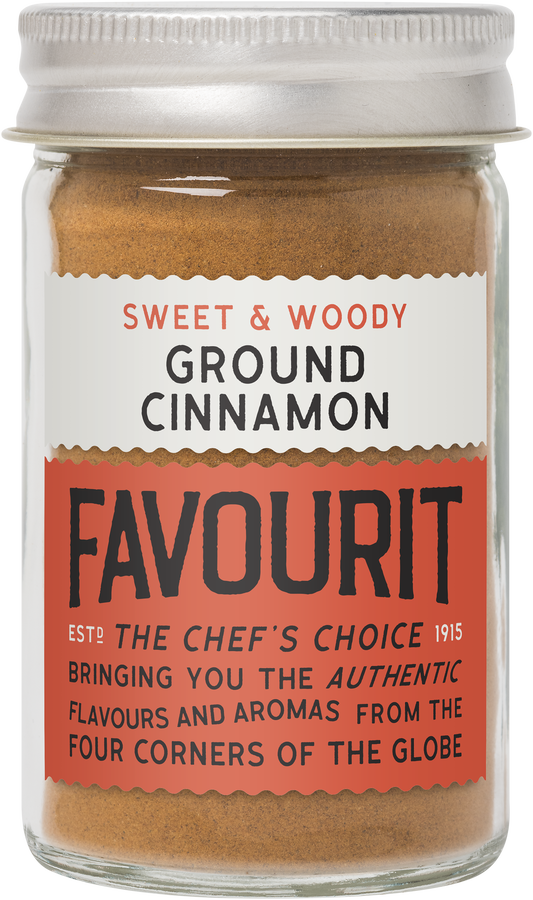 Jar labeled "Sweet & Woody Ground Cinnamon Favourit." Contains cinnamon powder with promotional text emphasizing authenticity and aromatic flavors.