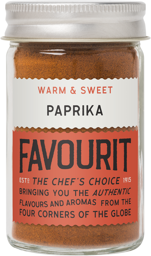 Glass jar of Favourit paprika labeled "Warm & Sweet," established 1915, featuring global flavors and aromas.